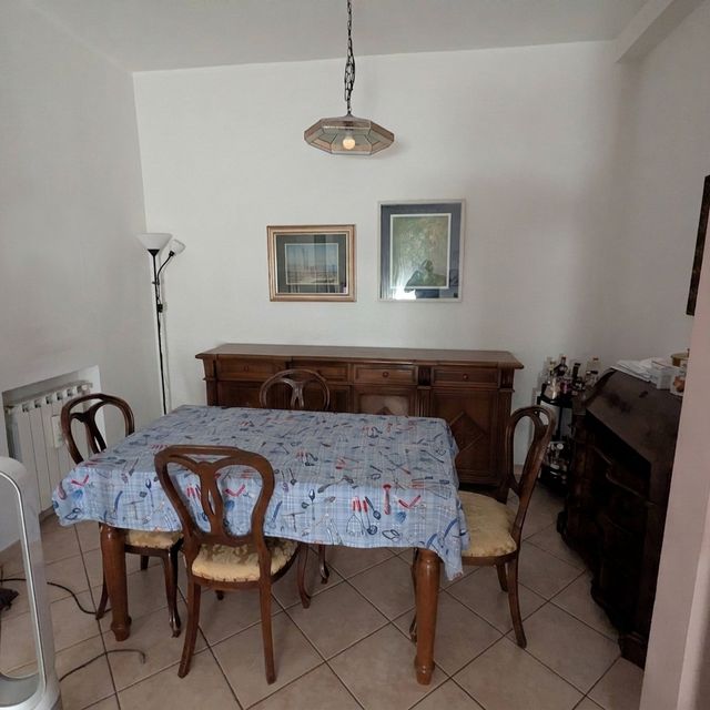 Sala da pranzo con tavolo, sedie e credenza in legno